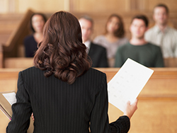 professional in courtroom with piece of paper