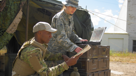 Military in field with laptop