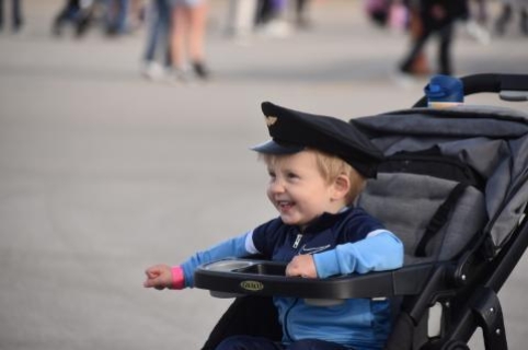 Child with pilot cap on head