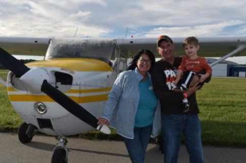 Family in front of a plane