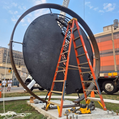 Site 7 sculpture top secured to concrete slab ladder for size reference