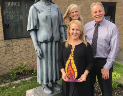 Lisa Louis, Catholic Foundation executive director, with Prince of Peace Center's executive director Joseph Flecher and board member Lisa Dach