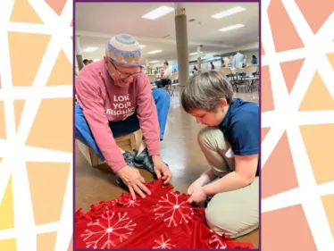 Part of the service day was creating fleece blankets for new refugee families.