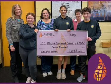 Lisa Louis (Executive Director) presents check to Cindy Zelanek (Teacher), Sr. Katherine Horan, OSB (Principal), Reese Wilczynski, Kaleena Huber, and Edward Terrizzi (students) of Blessed Sacrament School in Erie.