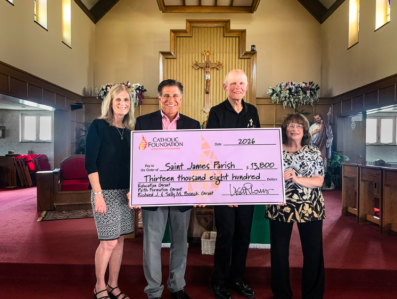 Lisa Louis, Executive Director, and Mike Bova, Board Vice Chair, present grant check to Deacon Dave Jacquel and Mary Shchouchkoff, faith formation leader, of Saint James Parish.