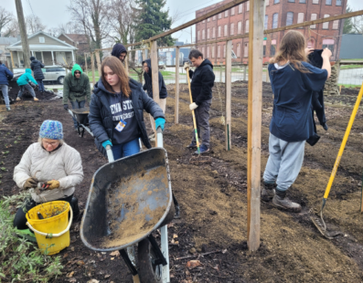 Teenagers and Garden Coaches planting seeds for Farmers Market at their Urban Garden