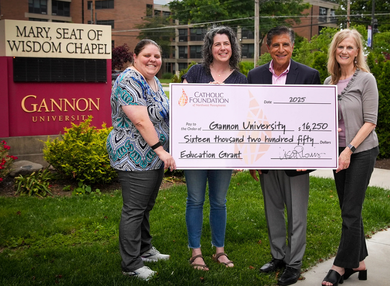 Lisa Louis (Executive Director, right) and Mike Bova (Foundation Board Vice Chair) present grant check to Gannon University Assistant Director of Campus Ministry, Emily Muntean (left) and Stacia Brown (Campus Minister).