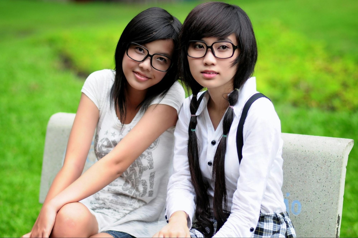 two women sitting on a bench