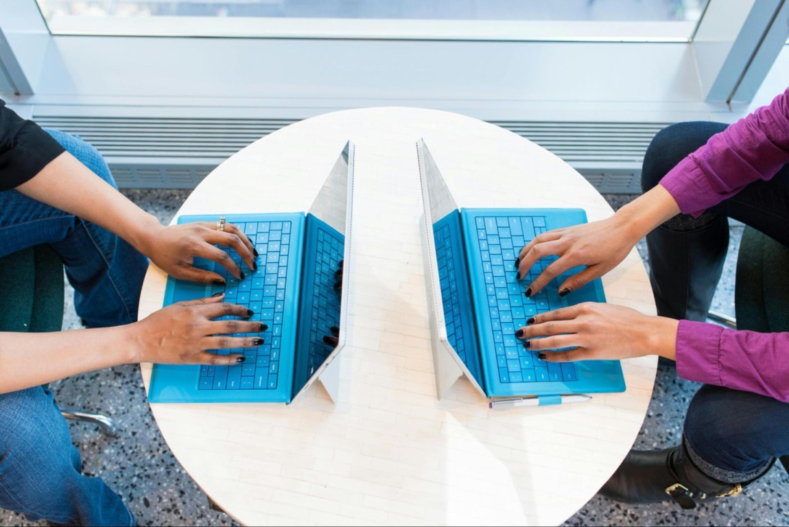 two women on laptops