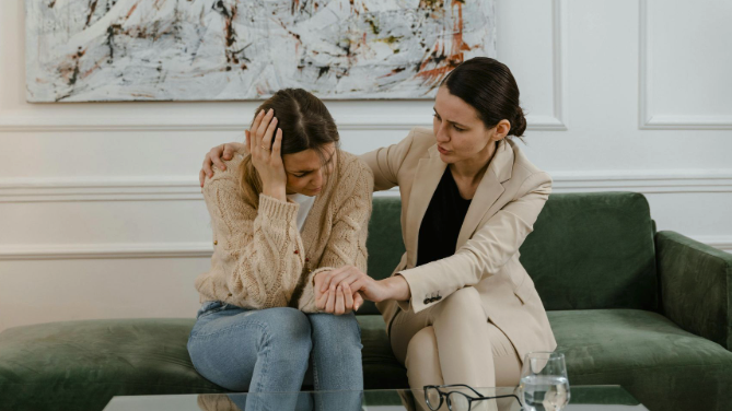 Woman comforting another woman