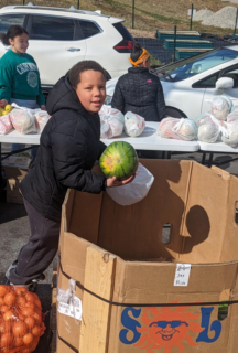 Boy wiht watermelon food bank